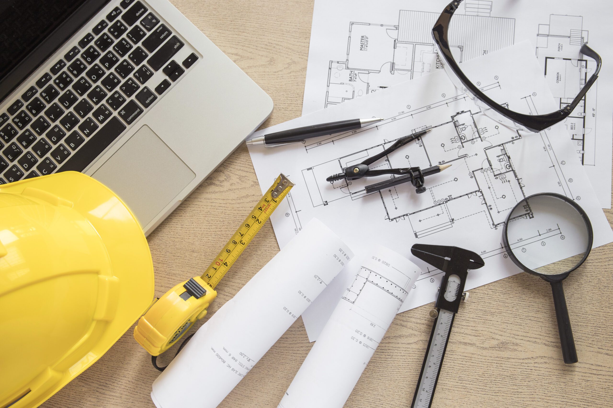 construction-supplies-drafts-near-laptop